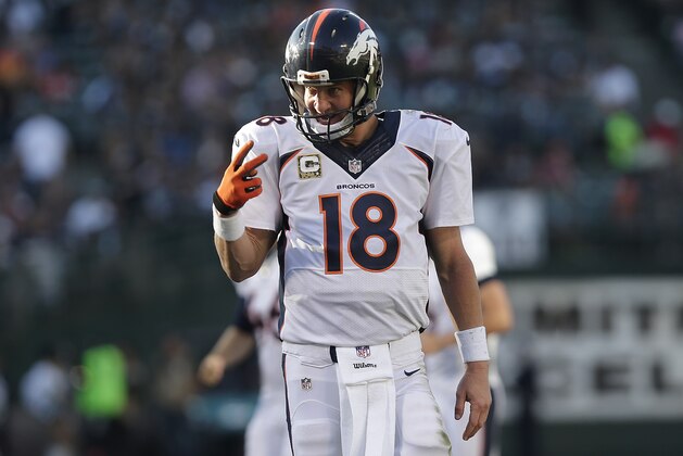 Denver Broncos quarterback Peyton Manning (18) reacts after throwing a 15-yard touchdown pass to wide receiver Emmanuel Sanders during the third quarter of an NFL football game against the Oakland Raiders in Oakland, Calif., Sunday, Nov. 9, 2014. (AP Photo/Marcio Jose Sanchez)