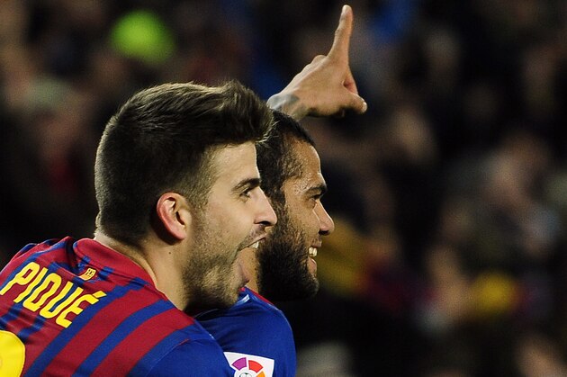 FC Barcelona's Daniel Alves from Brazil, right, celebrates with his teammate Gerard Pique after scoring against Real Madrid during a quarterfinal, second leg, Copa del Rey soccer match at the Camp Nou stadium, in Barcelona, Spain, Wednesday, Jan. 25, 2012. (AP Photo/Manu Fernandez)