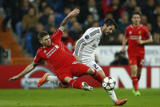 Liverpool's Javi Manquillo, left, and Real Madrid's Isco battle for the ball during a Group B Champions League soccer match between Real Madrid and Liverpool at the Santiago Bernabeu stadium in Madrid, Spain, Tuesday Nov. 4, 2014. (AP Photo/Andres Kudacki)