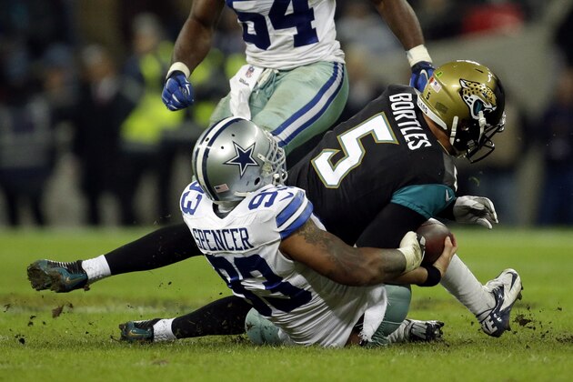 Jacksonville Jaguars quarterback Blake Bortles is sacked by Dallas Cowboys defensive end Anthony Spencer (93) during second half of the NFL football game at Wembley Stadium, London, Sunday, Nov. 9, 2014.  (AP Photo/Matt Dunham)