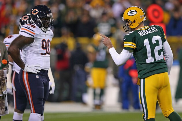 GREEN BAY, WI - NOVEMBER 09: Quarterback Aaron Rodgers #12 of the Green Bay Packers talks with the Chicago Bears defense, including  Jeremiah Ratliff #90, in the first half of the game at Lambeau Field on November 9, 2014 in Green Bay, Wisconsin. (Photo by Jonathan Daniel/Getty Images)