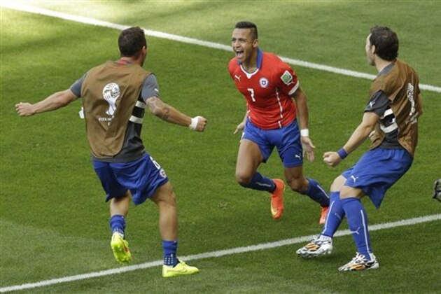 Chile's Alexis Sanchez celebrates with teammates after scoring their side's first goal during the World Cup round of 16 soccer match between Brazil and Chile at the Mineirao Stadium in Belo Horizonte, Brazil, Saturday, June 28, 2014. (AP Photo/Hassan Ammar)