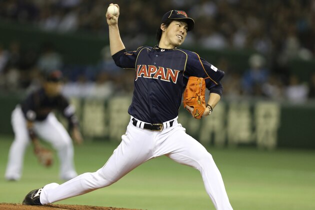 Japan's starter Kenta Maeda delivers a pitch against the Netherlands in the first inning of their World Baseball Classic second round game at Tokyo Dome in Tokyo, Sunday, March 10, 2013. (AP Photo/Toru Takahashi)