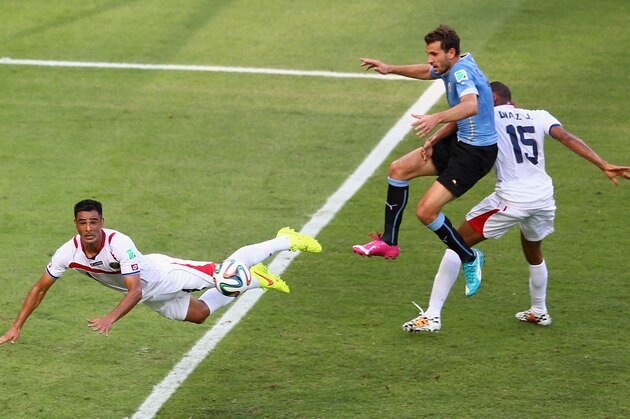 FORTALEZA, BRAZIL - JUNE 14: Walter Gargano (L) of Costa Rica heads clear during the 2014 FIFA World Cup Brazil Group D match between Uruguay and Costa Rica at Castelao on June 14, 2014 in Fortaleza, Brazil.  (Photo by Michael Steele/Getty Images)