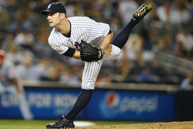 NEW YORK, NY - JULY 18:  David Robertson #30 of the New York Yankees pitches against the Cincinnati Reds in the ninth inning during their game at Yankee Stadium on July 18, 2014 in the Bronx borough of New York City.  (Photo by Al Bello/Getty Images)
