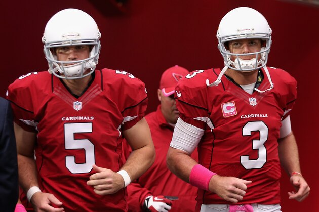GLENDALE, AZ - OCTOBER 12: Quarterback Drew Stanton #5 (left) and quarterback Carson Palmer #3 of the Arizona Cardinals (right) run on to the field before the NFL game against the Washington Redskins at the University of Phoenix Stadium on October 12, 2014 in Glendale, Arizona.  (Photo by Christian Petersen/Getty Images)