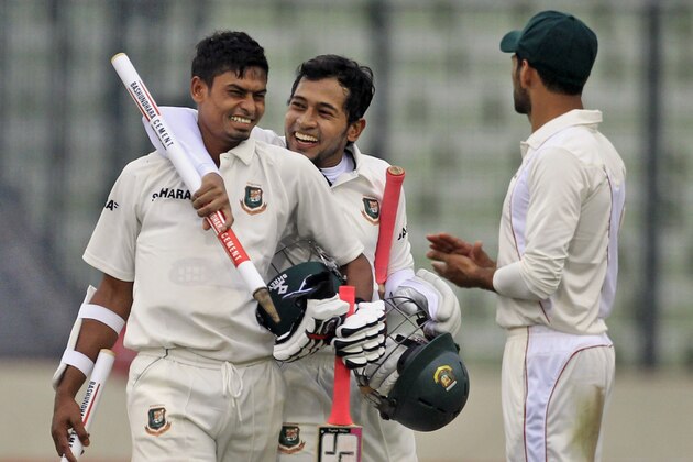 Bangladesh’s captain Mushfiqur Rahim, center, and Taijul Islam, left, celebrate after winning the first cricket test match against Zimbabwe in Dhaka, Bangladesh, Monday, Oct. 27, 2014. Bangladesh won by 3 wickets. (AP Photo/A.M. Ahad)