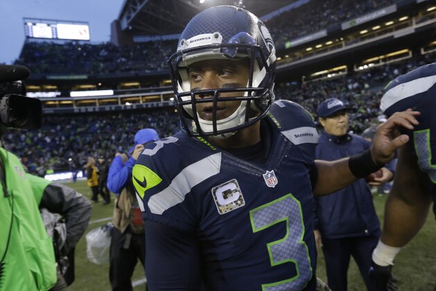 Seattle Seahawks quarterback Russell Wilson walks on the field after the team beat the New York Giants in an NFL football game, Sunday, Nov. 9, 2014, in Seattle. (AP Photo/Elaine Thompson)