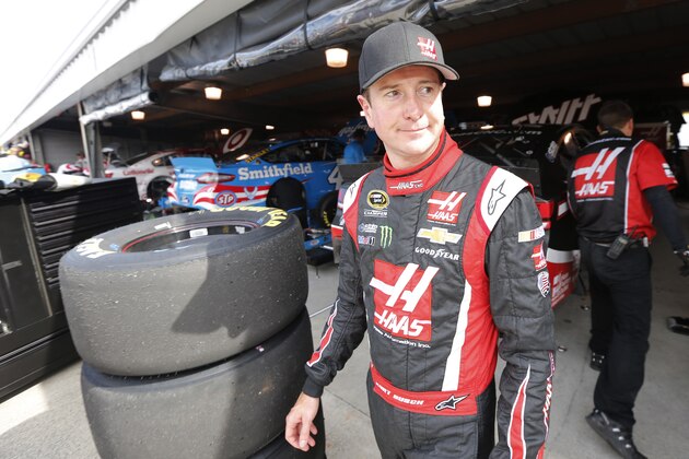 NASCAR driver Kurt Busch heads out of the garage after practice for Sunday's Sprint Cup Series auto race at Martinsville Speedway in Martinsville, Va., Friday, Oct. 24, 2014. Busch will get a new crew chief next week. (AP Photo/Steve Helber)