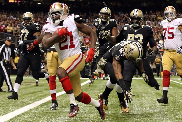 Nov 9, 2014; New Orleans, LA, USA; San Francisco 49ers running back Frank Gore (21) carries the ball to score a touchdown against the New Orleans Saints in the first quarter at Mercedes-Benz Superdome. Mandatory Credit: Chuck Cook-USA TODAY Sports