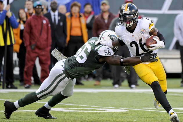 New York Jets' Demario Davis (56) tackles Pittsburgh Steelers' Le'Veon Bell (26) during the second half of an NFL football game Sunday, Nov. 9, 2014, in East Rutherford, N.J. (AP Photo/Bill Kostroun)