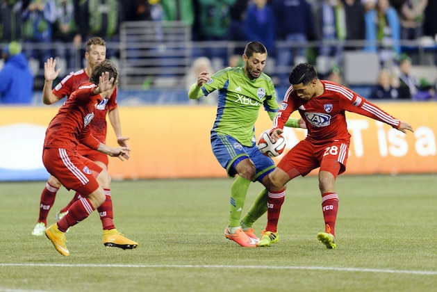 Nov 10, 2014; Seattle, WA, USA; Seattle Sounders FC forward Clint Dempsey (2) passes the ball while being defended by FC Dallas midfielder Victor Ulloa (28) during the first half at CenturyLink Field. Mandatory Credit: Steven Bisig-USA TODAY Sports