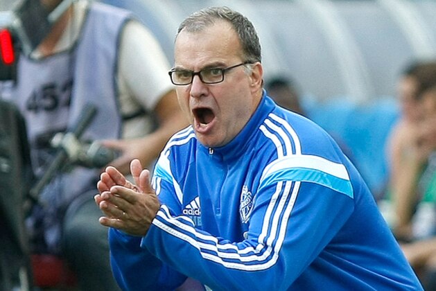 Marseille's Argentinian coach Marcelo Bielsa cheers on his team during their League One soccer match  against Toulouse, at the Velodrome Stadium, in Marseille, southern France, Sunday, Oct. 19, 2014. (AP Photo/Claude Paris)