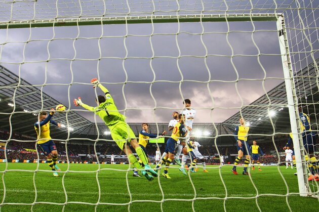 SWANSEA, WALES - NOVEMBER 09:  Ki Sung-Yueng of Swansea City heads goalwards during the Barclays Premier League match between Swansea City and Arsenal at Liberty Stadium on November 9, 2014 in Swansea, Wales.  (Photo by Michael Steele/Getty Images)