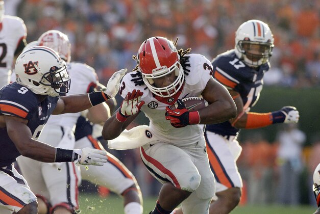 Nov 16, 2013; Auburn, AL, USA; Georgia Bulldogs running back Todd Gurley (3) is tackled by Auburn Tigers defensive back Jermaine Whitehead (9) during the first half against at Jordan Hare Stadium. Mandatory Credit: John Reed-USA TODAY Sports
