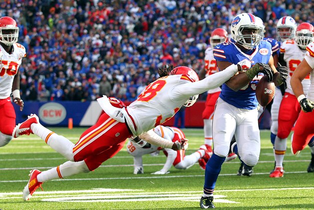 Kansas City Chiefs strong safety Ron Parker, left, forces a fumble off Buffalo Bills running back Bryce Brown during the second half of an NFL football game, Sunday, Nov. 9, 2014, in Orchard Park, N.Y. (AP Photo/Bill Wippert)
