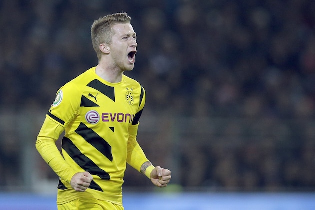 Dortmund's scorer Marco Reus shouts as he celebrates his side's second goal during the German soccer cup second round match between FC St. Pauli and Borussia Dortmund at the Millerntor Stadium in Hamburg, Germany, Tuesday, Oct. 28, 2014. (AP Photo/Michael Sohn)