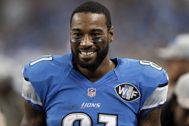 Detroit Lions wide receiver Calvin Johnson smiles on the sidelines against the Miami Dolphins during the first half of an NFL football game in Detroit, Sunday, Nov. 9, 2014. (AP Photo/Paul Sancya)
