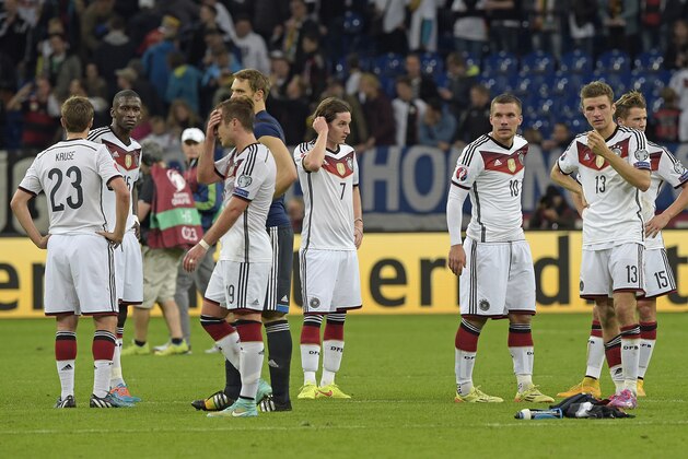 Germany's players stand on the pitch after the Euro 2016 group D qualifying soccer match between Germany and Ireland in Gelsenkirchen, Germany, Tuesday, Oct. 14, 2014. The match ended 1-1. (AP Photo/Martin Meissner)