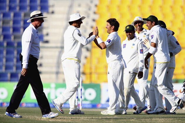 ABU DHABI, UNITED ARAB EMIRATES - NOVEMBER 11:  Yasir Shah of Pakistan celebrates the run out of Mark Craig of New Zealand  during Day Three of the First Test between Pakistan and New Zealand at Sheikh Zayed stadium on November 11, 2014 in Abu Dhabi, United Arab Emirates.  (Photo by Francois Nel/Getty Images)