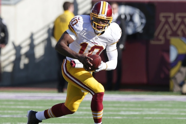 FILE - In this Nov. 2, 2014, file photo, Washington Redskins quarterback Robert Griffin III (10) runs for extra yardage during the first half of an NFL football game against the Minnesota Vikings in Minneapolis. Griffin was The Associated Press Offensive Rookie of the Year in 2012 when he helped the Redskins overcome a 3-6 start to win seven straight games and the NFC East title. But he tore his ACL in a playoff loss to Seattle and has had three major leg injuries over six college and NFL seasons. (AP Photo/Jim Mone, File)