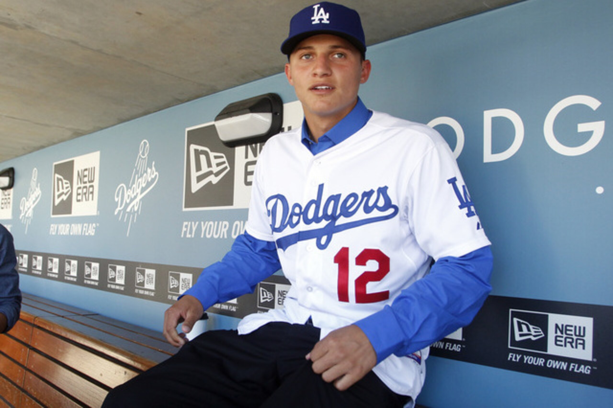 Los Angeles Dodgers infield prospect Corey Seager sits in the dugout prior to the team playing against the New York Mets in their baseball game in Los Angeles, Saturday, June 30, 2012. Corey Seager, selected 18th overall in the baseball draft, agreed to forgo a scholarship to South Carolina to sign a contract with a $2.35 million signing bonus Friday. (AP Photo/Alex Gallardo)