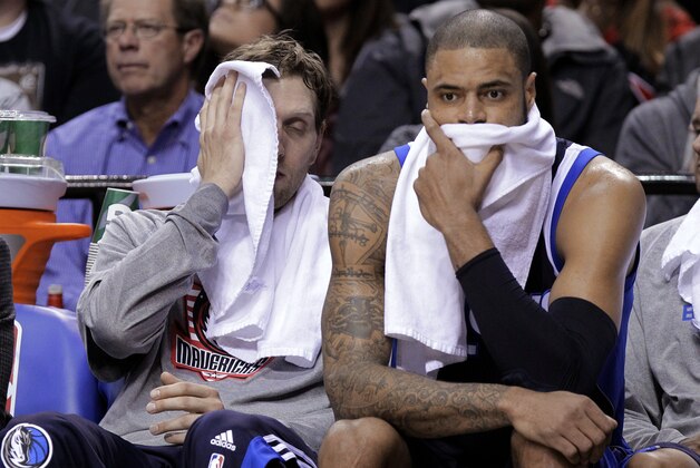 Dallas Mavericks forward Dirk Nowitzki, left, and center Tyson Chandler sit on the bench late in the second half of an NBA basketball game against the Portland Trail Blazers in Portland, Ore., Thursday, Nov. 6, 2014.  Portland won 108-87. (AP Photo/Don Ryan)