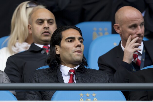 Manchester United's Radamel Falcao Garcia sits in the stands before his team's English Premier League soccer match against Manchester City at the Etihad Stadium, Manchester, England, Sunday Nov. 2, 2014. (AP Photo/Jon Super)