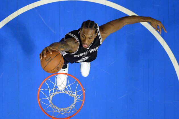 San Antonio Spurs forward Kawhi Leonard dunks during the second half of an NBA basketball game against the Los Angeles Clippers, Monday, Nov. 10, 2014, in Los Angeles. The Spurs won 89-85. (AP Photo/Mark J. Terrill)