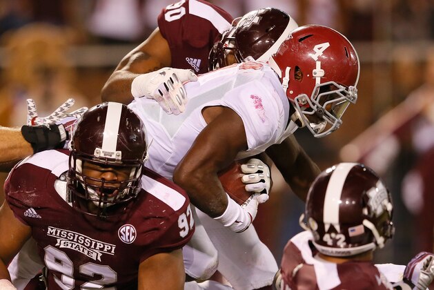 STARKVILLE, MS - NOVEMBER 16:  T.J. Yeldon #4 of the Alabama Crimson Tide rushes against Kaleb Eulls #92 and Denico Autry #90 of the Mississippi State Bulldogs at Davis Wade Stadium on November 16, 2013 in Starkville, Mississippi.  (Photo by Kevin C. Cox/Getty Images)