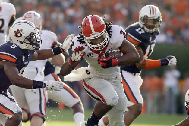 Nov 16, 2013; Auburn, AL, USA; Georgia Bulldogs running back Todd Gurley (3) is tackled by Auburn Tigers defensive back Jermaine Whitehead (9) during the first half against at Jordan Hare Stadium. Mandatory Credit: John Reed-USA TODAY Sports