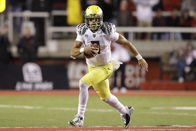 Oregon quarterback Marcus Mariota (8) carries the ball in the second half during an NCAA college football game against Utah Saturday, Nov. 8, 2014, in Salt Lake City. Oregon  won 51-27. (AP Photo/Rick Bowmer)