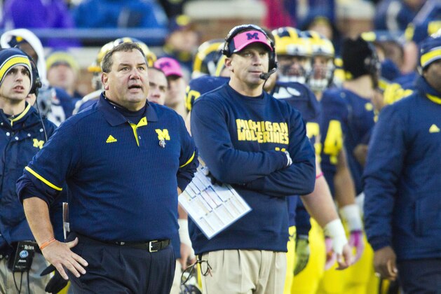 Michigan head coach Brady Hoke, left, stand by offensive coordinator Doug Nussmeier on the sideline in the fourth quarter of an NCAA college football game against Indiana in Ann Arbor, Mich., Saturday, Nov. 1, 2014. Michigan won 34-10. (AP Photo/Tony Ding)