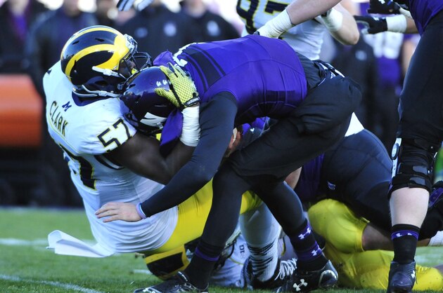 EVANSTON IL - NOVEMBER 08: Matt Alviti #7 of the Northwestern Wildcats lis sacked by Frank Clark #57 of the Michigan Wolverines during the first half on November 8, 2014 at Ryan Field in Evanston, Illinois.  (Photo by David Banks/Getty Images)