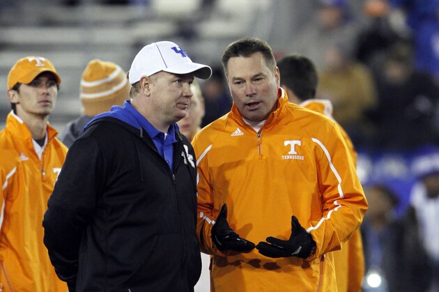 Nov 30, 2013; Lexington, KY, USA; Tennessee Volunteers head coach Butch Jones and Kentucky Wildcats head coach Mark Stoops talk before the game at Commonwealth Stadium. Mandatory Credit: Mark Zerof-USA TODAY Sports