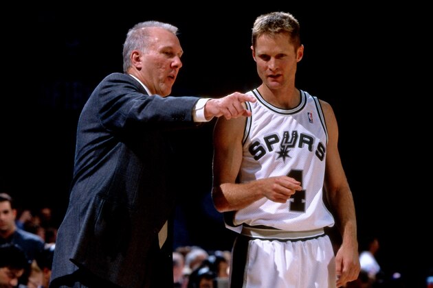 MILAN, ITALY - OCTOBER 15: Steve Kerr #4 and Gregg Popovich of the San Antonio Spurs talk against Varese Roosters as part of the 1999 McDonald's Championships on October 15, 1999 at the Fila Forum in Milan Italy. The San Antonio Spurs defeated Varese Roosters 96-86. NOTE TO USER: User expressly acknowledges and agrees that, by downloading and or using this photograph, User is consenting to the terms and conditions of the Getty Images License Agreement. Mandatory Copyright Notice: Copyright 1999 NBAE (Photo by Nathaniel S. Butler/NBAE via Getty Images)