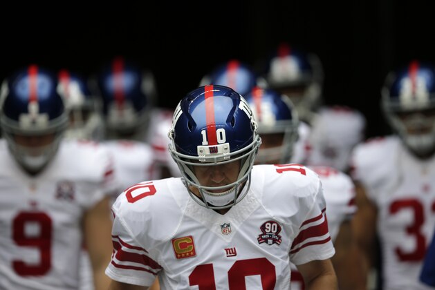 New York Giants quarterback Eli Manning (10) leads his team out of the tunnel for warmups before an NFL football game against the Seattle Seahawks, Sunday, Nov. 9, 2014, in Seattle. (AP Photo/Scott Eklund)