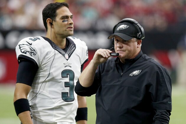 Philadelphia Eagles head coach Chip Kelly makes a call as Mark Sanchez (3) stands near during the first half of an NFL football game against the Arizona Cardinals, Sunday, Oct. 26, 2014, in Glendale, Ariz. (AP Photo/Ross D. Franklin)