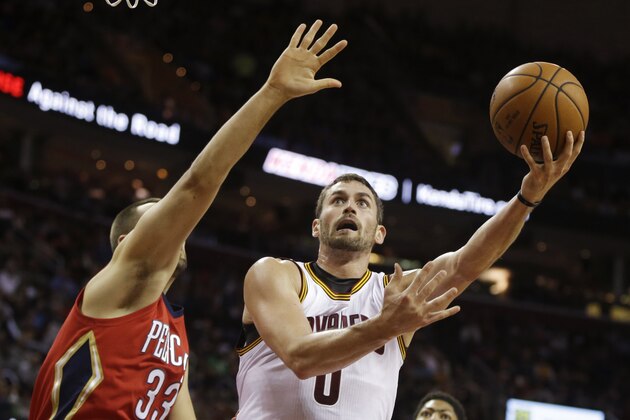 Cleveland Cavaliers' Kevin Love (0) shoots against New Orleans Pelicans' Ryan Anderson in the first quarter of an NBA basketball game Monday, Nov. 10, 2014, in Cleveland. (AP Photo/Mark Duncan)