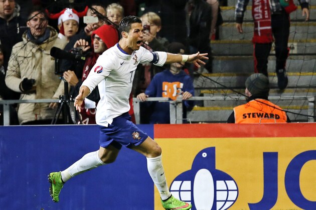 Christiano Ronaldo celebrates his last minute goal during a Euro 2016 group I qualifying soccer match between Denmark and Portugal in Copenhagen, Denmark,Tuesday, Oct. 14, 2014. (AP Photo/Jens Dresling/POLFOTO)  DENMARK OUT