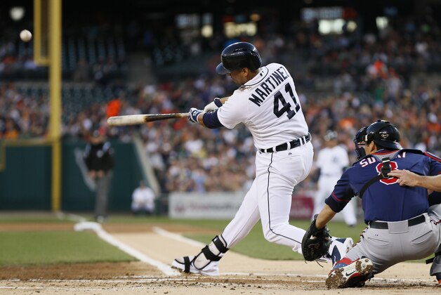 Detroit Tigers' Victor Martinez (41) hits a two-run home run off Minnesota Twins pitcher Trevor May in the first inning of a baseball game in Detroit, Thursday, Sept. 25, 2014. (AP Photo/Paul Sancya)