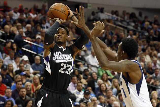 Sacramento Kings' Ben McLemore (23) goes up for a shot in front of Dallas Mavericks' Al-Farouq Aminu, right, in the first half of an NBA basketball game, Tuesday, Nov. 11, 2014, in Dallas. (AP Photo/Tony Gutierrez)