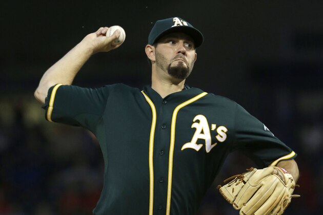 Oakland Athletics starting pitcher Jason Hammel throws during the first inning of a baseball game against the Texas Rangers in Arlington, Texas, Thursday, Sept. 25, 2014. (AP Photo/LM Otero)