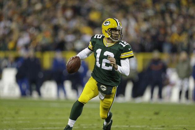 GREEN BAY, WI - NOVEMBER 9:  Aaron Rodgers #12 of the Green Bay Packers rolls out of the pocket during the game against the Chicago Bears at Lambeau Field on November 9, 2014 in Green Bay, Wisconsin. The Packers defeated the Bears 55-14. (Photo Tom Lynn /Getty Images)
