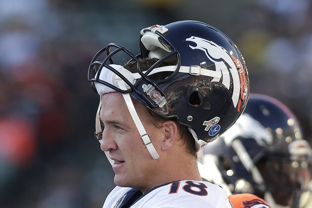 Denver Broncos quarterback Peyton Manning (18) stands on the sideline during the second half of an NFL football game against the Oakland Raiders in Oakland, Calif., Sunday, Nov. 9, 2014. (AP Photo/Marcio Jose Sanchez)