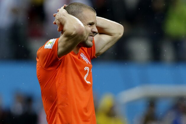 Netherlands' Ron Vlaar reacts after missing his shot during a penalty shootout after extra time during the World Cup semifinal soccer match between the Netherlands and Argentina at the Itaquerao Stadium in Sao Paulo Brazil, Wednesday, July 9, 2014. Argentina defeated the Netherlands 4-2 in a penalty shootout after a 0-0 tie to advance to the finals. (AP Photo/Victor R. Caivano)