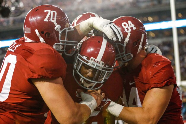 Nov 8, 2014; Baton Rouge, LA, USA; Alabama Crimson Tide wide receiver DeAndrew White (2) celebrates with teammates offensive lineman Ryan Kelly (70) and tight end Brian Vogler (84) after catching a touchdown against the LSU Tigers during the overtime of a game at Tiger Stadium. Alabama defeated LSU 20-13 in overtime. Mandatory Credit: Derick E. Hingle-USA TODAY Sports