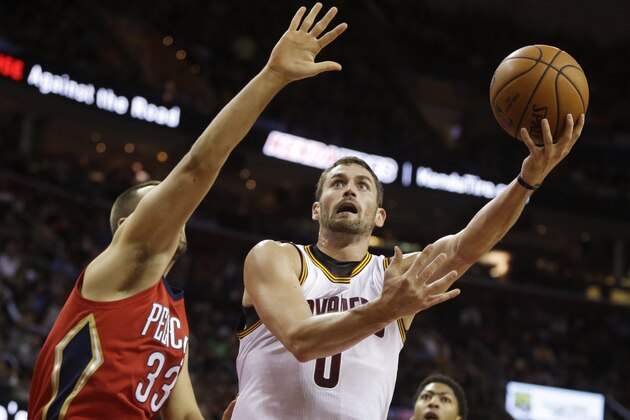 Cleveland Cavaliers' Kevin Love (0) shoots against New Orleans Pelicans' Ryan Anderson in the first quarter of an NBA basketball game Monday, Nov. 10, 2014, in Cleveland. (AP Photo/Mark Duncan)