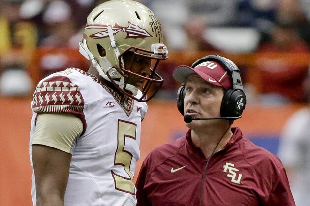 Florida State head coach Jimbo Fisher, right, talks to quarterback Jameis Winston (5) during the second half of an NCAA college football game against Syracuse, Saturday, Oct. 11, 2014, in Syracuse, N.Y. Florida State won the game 38-20. (AP Photo/Frank Franklin II)