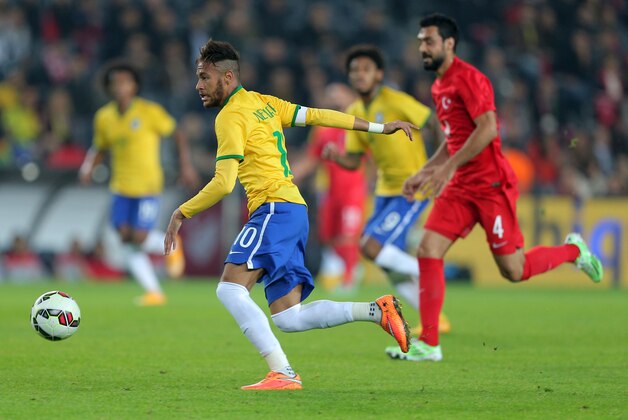 Brazil's Neymar JR, left, in action during their friendly soccer match with Turkey at Sukru Saracoglu Stadium in Istanbul, Turkey, Wednesday, Nov. 12, 2014. (AP Photo)